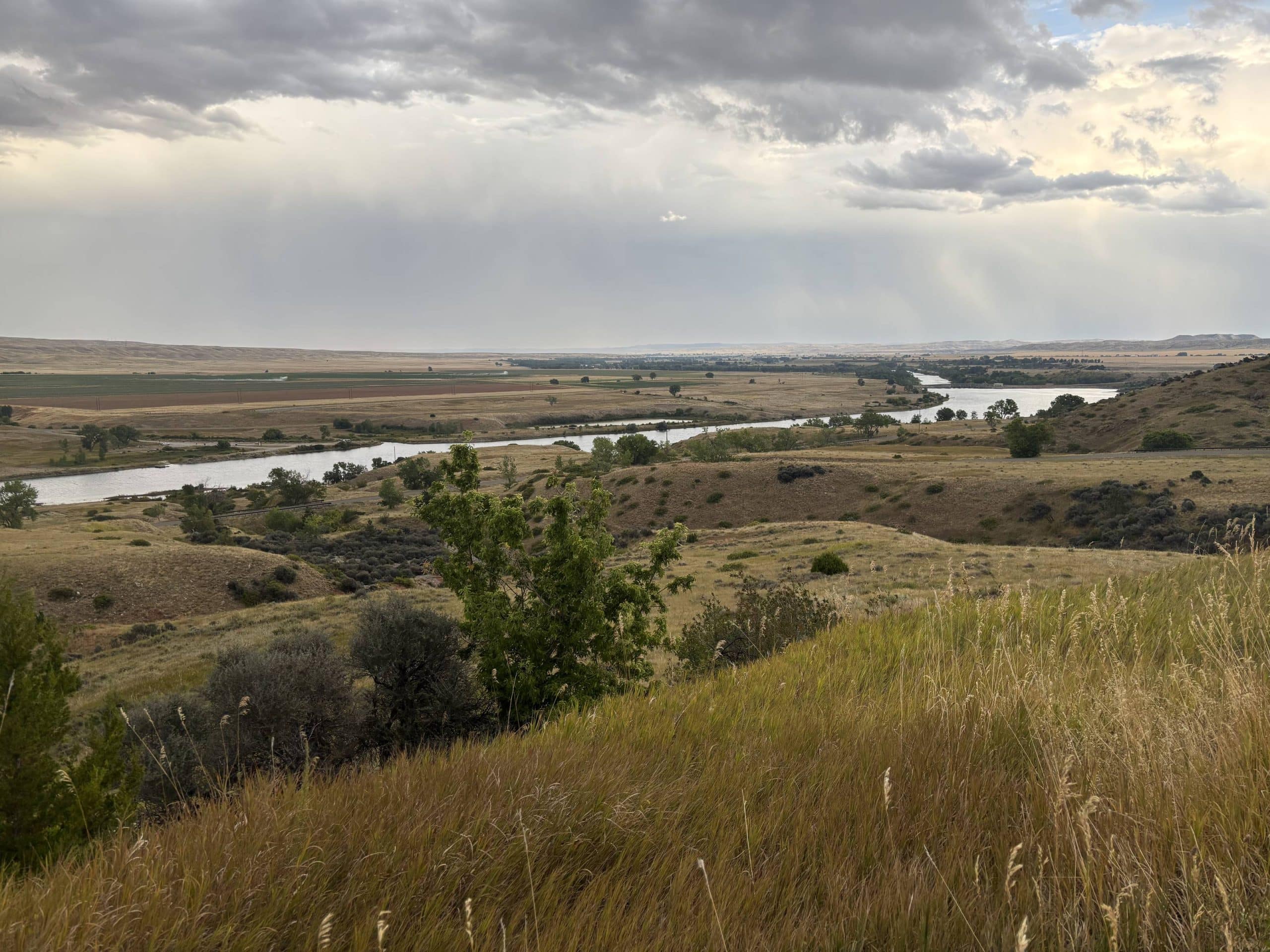 Long shot of bighorn canyon river moving through grasslands